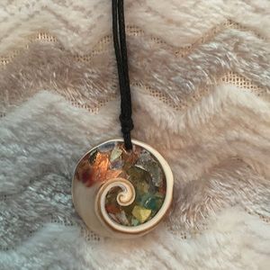 Shell necklace with small colored stones inside on thin black stringed lanyard